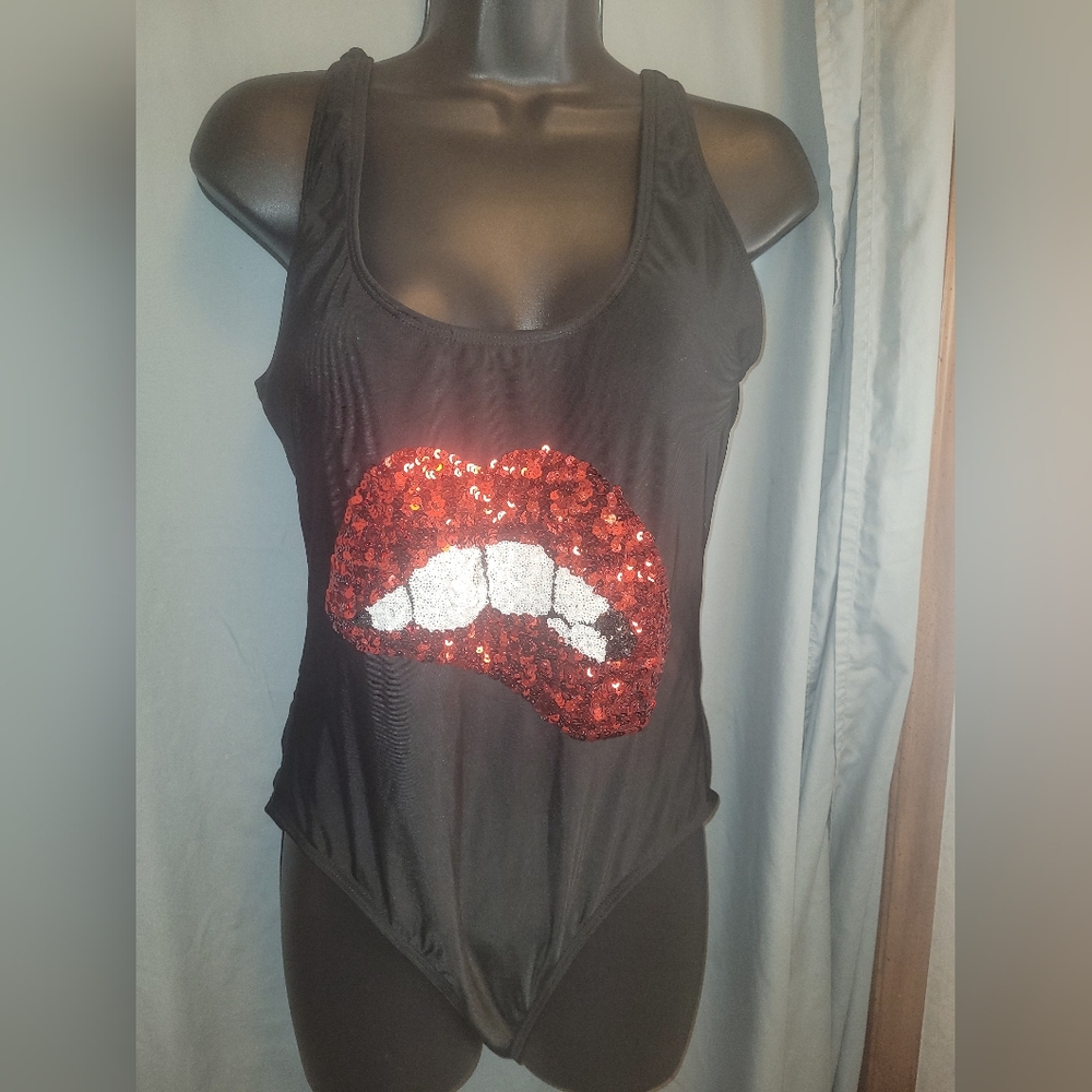 One-piece black swimsuit with sequin red lip graphics. Size L.